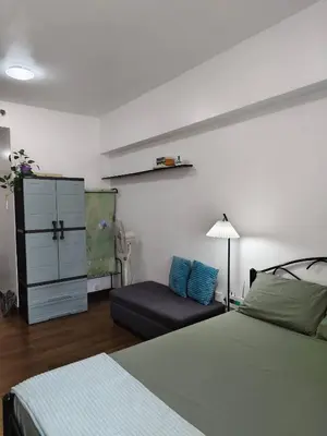 a bedroom with a bed and a chair and a dresser at Windsong Suite Unli Netflix Disney Roofdeck View in Manila