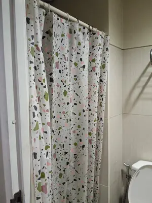 a bathroom with a shower curtain with animals on it at Serene Pasay Getaway - Entire Apartment for Rent in Manila