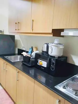 a kitchen counter with a microwave and a sink at Relax in Pasay City at Shell Residences - Your Home Away from Home in Manila