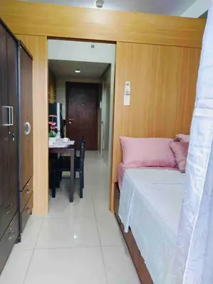 a room with a bed and a table with a tableablish at Relax in Pasay City at Shell Residences - Your Home Away from Home in Manila
