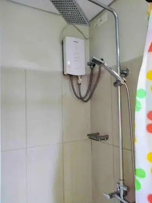 a shower head in a bathroom with a shower curtain at Relax in Pasay City at Shell Residences - Your Home Away from Home in Manila