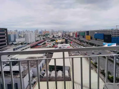 arial view of a city with traffic on a highway at Relax in Pasay City at Shell Residences - Your Home Away from Home in Manila