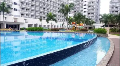 a large swimming pool in front of a building at Relax in Pasay City at Shell Residences - Your Home Away from Home in Manila
