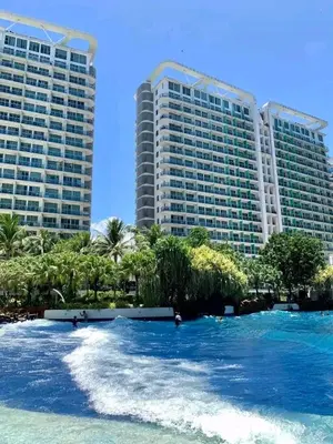 a body of water with two tall buildings in the background at 1BR Unit Azure Urban Resort Residences in Manila