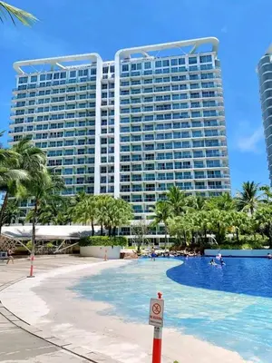 a large building with a pool in front of a resort at 1BR Unit Azure Urban Resort Residences in Manila