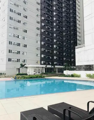 a large swimming pool with two tall buildings at 1Bedroom for rent Amaia Skies Shaw in Manila