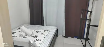 a small bed in a small room with a white and black at Sea Residences Yanah Staycation in Manila