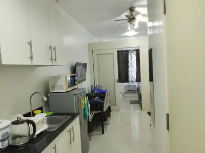 a kitchen with a sink and a counter top at Sea Residences Yanah Staycation in Manila