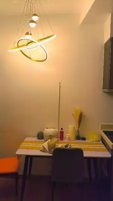 a table in a kitchen with a light fixture at Milano residences in Manila