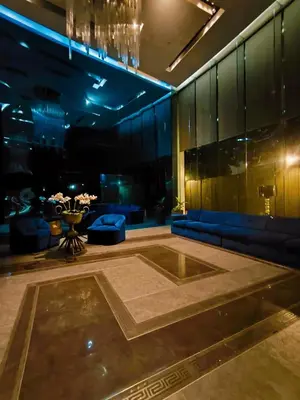 a lobby with a large pool in the middle of a room at Milano residences in Manila