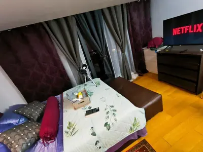 a room with a bed with a table and a television at Milano residences in Manila