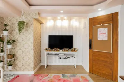 a living room with a television on a table at Devi Suite 2BR BGC Taguig in Manila