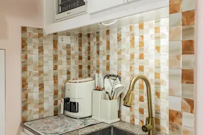 a kitchen with a coffee maker and a sink at Devi Suite 2BR BGC Taguig in Manila