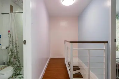 a bathroom with a toilet and a glass shelf at Devi Suite 2BR BGC Taguig in Manila