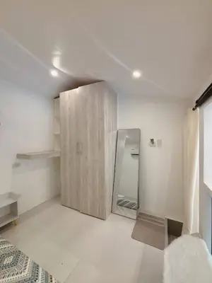 a bedroom with a mirror and a bed in it at Cozy Loft Condo in Tanza with Arcade in Tanza