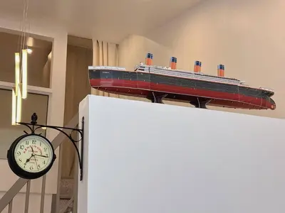 a model of a cruise ship sitting on top of a wall at Cozy Loft Condo in Tanza with Arcade in Tanza