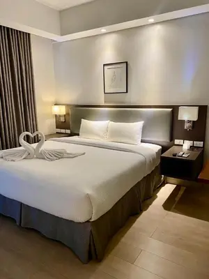 a bedroom with a large bed in a hotel room at Superior Studio Urban Escapes at BCCT in Manila