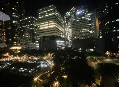 a view of a city at night with lights at Forbeswood Parklane Condominium in Manila