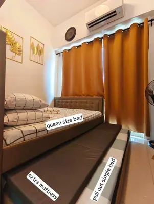 a room with two beds in a room with price signs at The C Place Mla in Manila
