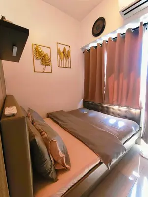 a small bed in a room with a window at The C Place Mla in Manila