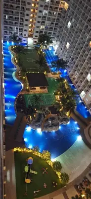 an aerial view of a large building with a tennis court at The C Place Mla in Manila