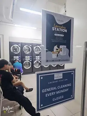 a woman sitting in a chair in front of a laundry station at V-TAN condo in Manila