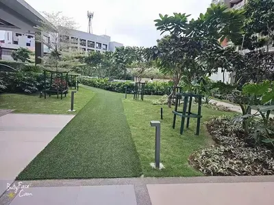 a park with benches and trees in a building at V-TAN condo in Manila