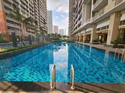 a large blue swimming pool in a building at V-TAN condo in Manila
