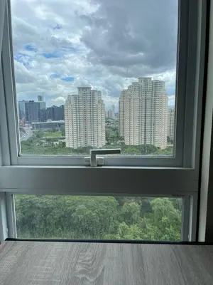 a window with a view of a city at Cozy Nook in the City in Manila