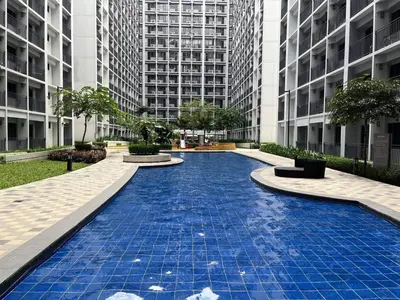 a blue tile walkway in a city with tall buildings at Metro Prime Stays at Shore 2 Residences in Manila