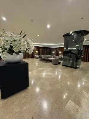 a lobby with a vase with white flowers in it at Metro Prime Stays at Shore 2 Residences in Manila