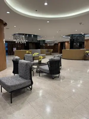 a lobby with chairs and a table in a building at Metro Prime Stays at Shore 2 Residences in Manila