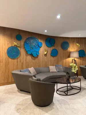 a living room with a couch and blue plates on the wall at Metro Prime Stays at Shore 2 Residences in Manila