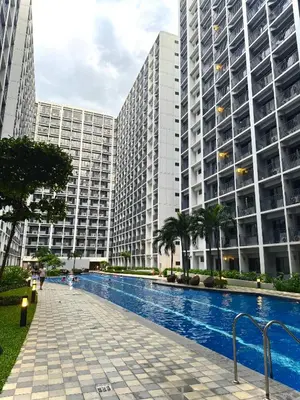 a swimming pool in front of two tall buildings at Philhaus Staycation in Manila
