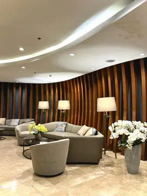 a living room with couches and tables and flowers at Philhaus Staycation in Manila