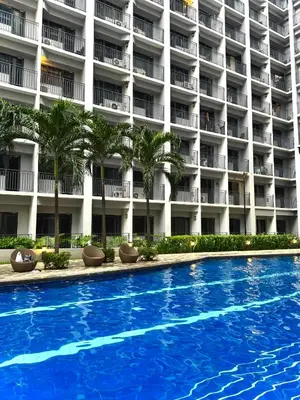 a swimming pool in front of a hotel at Philhaus Staycation in Manila