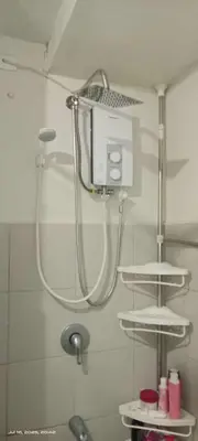 a shower in a bathroom with a shower head at Capsule bed room in Manila