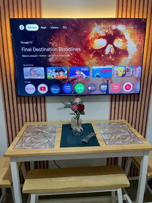 a table with a tv on top of it at Teychi's Staycation at Shore2 MOA Pasay in Manila