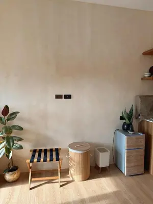 a living room with a bench and a refrigerator at Zen Staycation with City and Sunset View near Airport and Mckinley in Manila