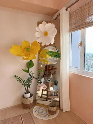 a room with yellow and white flowers on the wall at Zen Staycation with City and Sunset View near Airport and Mckinley in Manila
