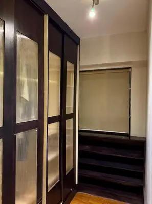 an empty closet with a sliding glass door at WestParc Cedar Cozy Apartment in the Heart of Alabang in Manila