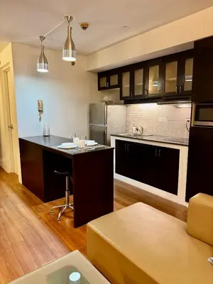 a kitchen with a table and a counter top at WestParc Cedar Cozy Apartment in the Heart of Alabang in Manila