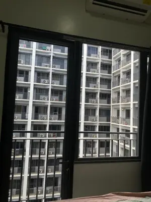 a bedroom window with a view of a apartment building at Shore 2 Tower 1 in Manila