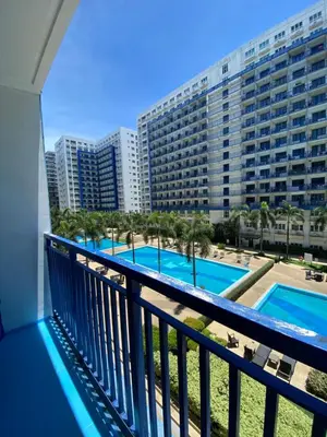 a view of the pool from the balcony of a resort at Sea Residences Santorini Vibes - Reynil in Manila