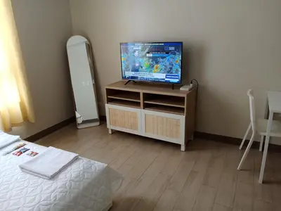 a bedroom with a tv on a dresser with a bed at The Verdin Brand-New Unit with Pool, Gym, & High-Speed Wi-fi in General Trias