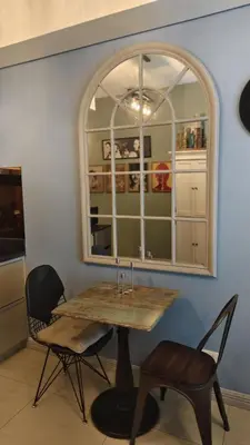 a table and chairs in a kitchen with a window at Studio Premier Suite Makatii by Christine Suites PH in Manila