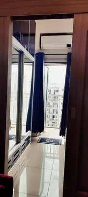 a room with a mirror and a large window at Carps Staycation in Manila