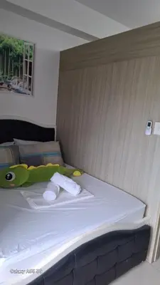a bed with two towels on it in a room at Carps Staycation in Manila