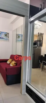 a bedroom with a red bed and a mirror at Carps Staycation in Manila