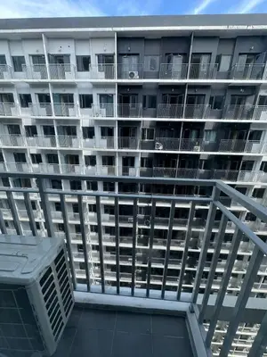 an empty apartment building with balconies on the side at Mall of Asia shore 3 Tower 21661 Residence in Manila